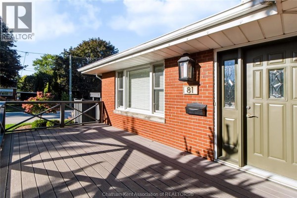 Close-up of the front entrance with a green door, address number 81, and a dark gray composite deck. - 81 Devon Road, Chatham