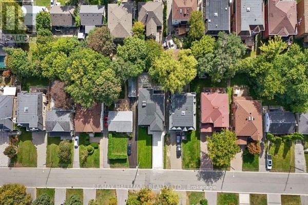 Aerial view of residential street with closely packed houses, mature trees, and manicured lawns. - 81 Meadowview Avenue, Markham
