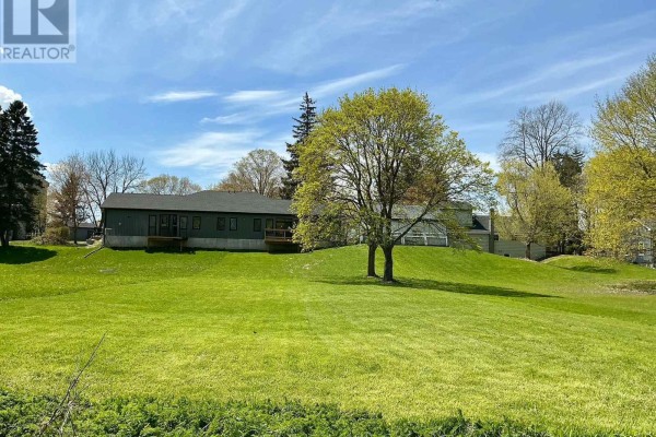 View of a calm river with green trees and grass on the banks. - 81 Sports Drive, Huron East