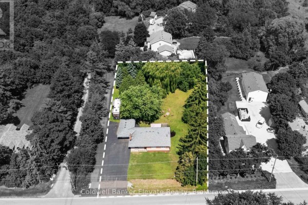 Aerial view showing the property boundaries of a bungalow with a large lot and mature trees. - 81 Tremaine Road, Milton
