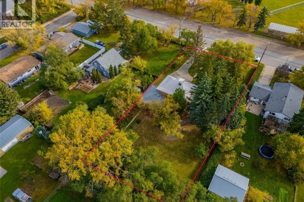 Aerial view of a residential neighborhood with multiple houses and trees. - 810 4th Avenue, Rosthern