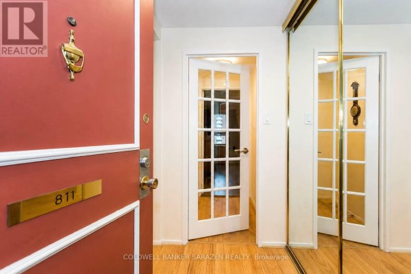 Interior hallway with light beige walls and glass-paneled door. - 811 - 1356 Meadowlands Drive E, Ottawa