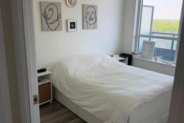 Bedroom with white platform bed, art, and large window - 811 - 2 Anndale Drive Toronto