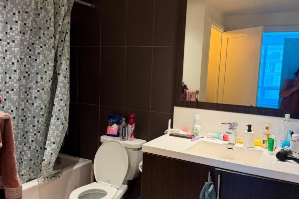 Bathroom with bathtub, toilet, vanity, dark wood cabinets - 811 - 2 Anndale Drive Toronto
