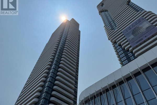 Looking up at tall condo towers with distinctive wavy balconies. - 811 - 28 Interchange Way, Vaughan
