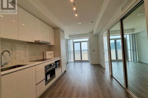 A bright, modern kitchen with light wood cabinets and stainless steel appliances. - 811 - 28 Interchange Way, Vaughan