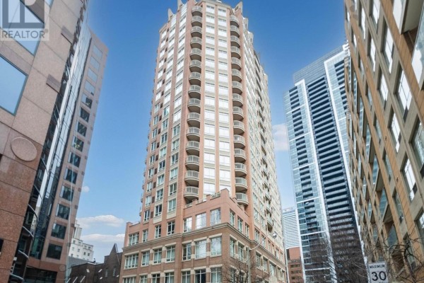 Exterior view of the tall brick Bloor Walk Residences building surrounded by modern skyscrapers. - 812 - 100 Hayden Street, Toronto