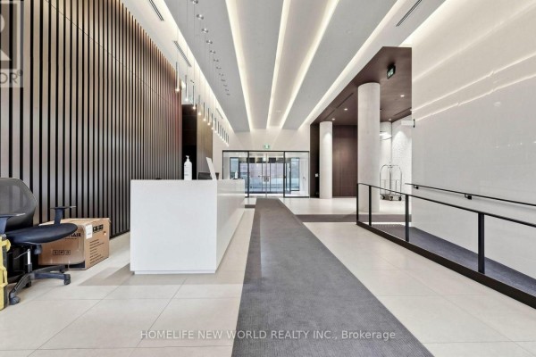 Modern lobby with a white reception desk, wood accent wall, and tiled floor. - 813 - 158 Front Street E, Toronto
