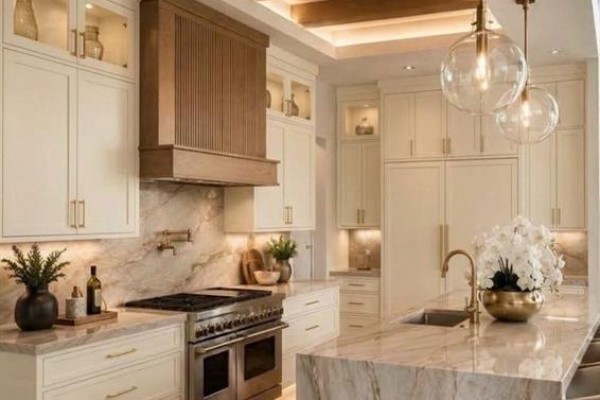 Gourmet kitchen with cream cabinets, marble countertops, stainless steel range, and island. - 814 22 Avenue Nw, Calgary