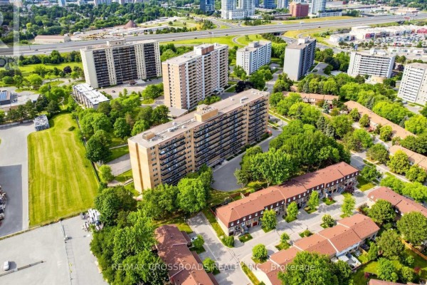 Aerial view of apartment buildings surrounded by trees and parkland. - 817 - 100 Dundalk Drive, Toronto