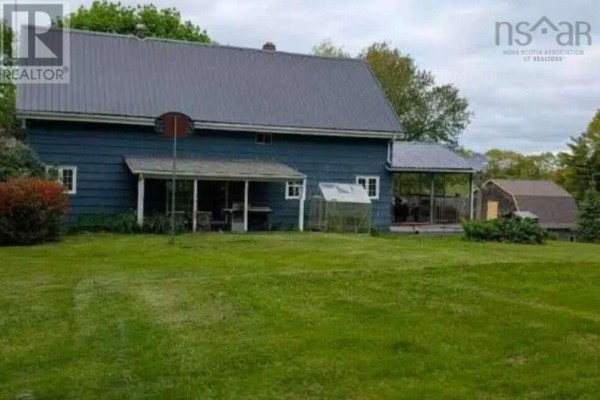 Wooden porch with a railing and hanging plants on a blue house. - 8178 Nova Scotia Trunk 8, South Brookfield