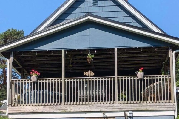 Exterior of a weathered wood barn with yellow double doors and a star decoration. - 8178 Nova Scotia Trunk 8, South Brookfield