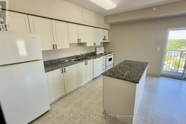 Kitchen with white cabinets, granite countertops, white appliances, and island. - 818 - 239 Auburn Drive, Waterloo