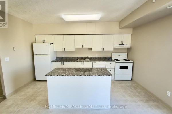Kitchen with white cabinets, granite countertops, white appliances, and central island. - 818 - 239 Auburn Drive, Waterloo