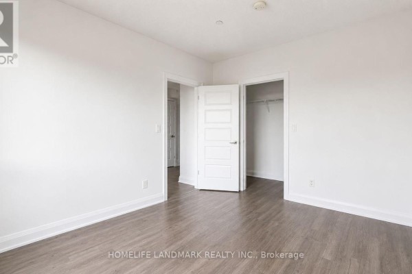 Apartment bedroom with white doors, one opening to a closet and the other to a hallway. - 819 - 15 Water Walk Drive, Markham