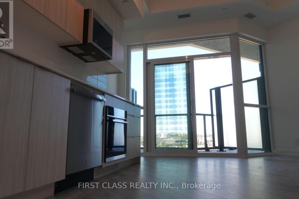 Kitchen with dishwasher, oven, and large balcony windows with city view. - 819 - 20 Deans Drive, Toronto