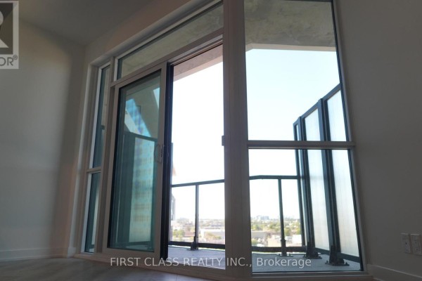 Interior view of a balcony with glass railings and expansive city views. - 819 - 20 Deans Drive, Toronto