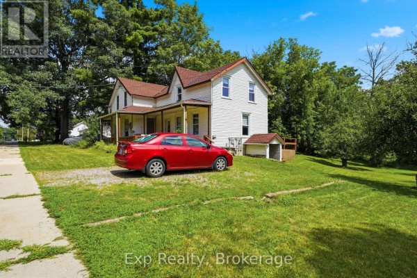 Exterior view of a white house with a red car parked on the gravel driveway. - 82 - 84 Bursthall Street, Marmora And Lake