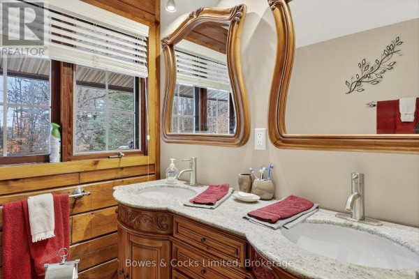 Double vanity with granite countertops and ornate wood cabinets - 82 Bay Lake Road Bancroft