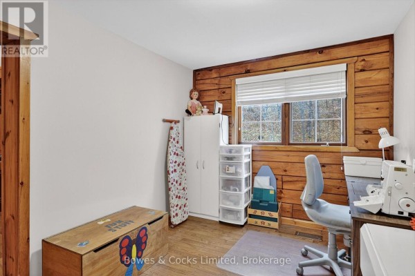 Craft room with sewing machine, ironing board, and toy chest - 82 Bay Lake Road Bancroft
