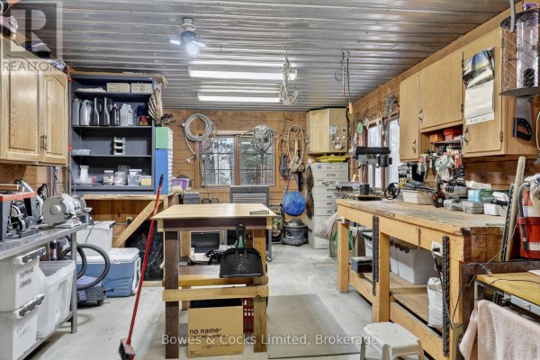 Workshop with workbenches, tools, and storage - 82 Bay Lake Road Bancroft