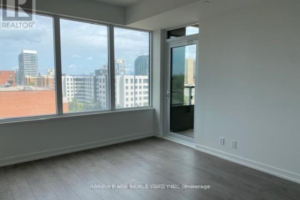 Bright living space with floor-to-ceiling windows and a sliding glass door to a balcony. - 822 - 270 Dufferin Street, Toronto