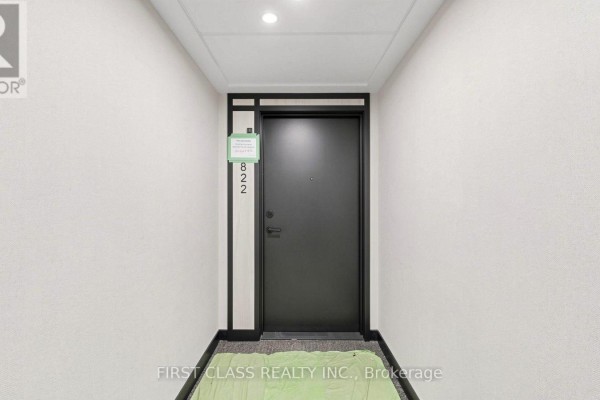 Spacious balcony with gray tile flooring and metal railing overlooking city. - 822 - 91 Montclair Avenue, Toronto