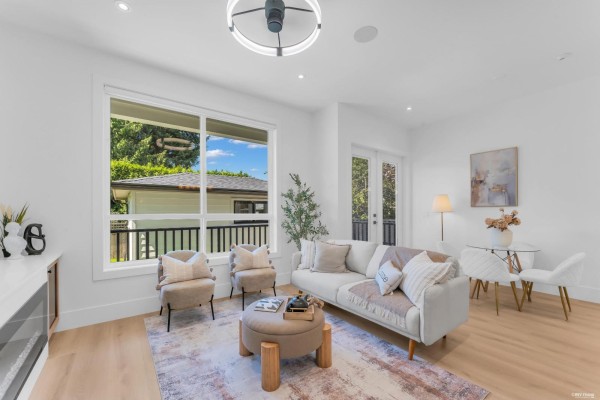 Living room featuring a sofa, chairs, coffee table, and a glimpse of the dining area. - 8221 111b Street, Delta