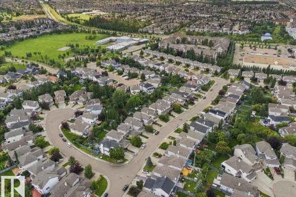 Aerial view of a large suburban neighbourhood with many houses and streets. - 824 Barnes Li Sw, Edmonton
