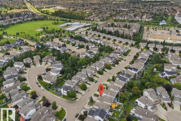 Aerial view of a residential neighbourhood with many houses and some green parkland. - 824 Barnes Li Sw, Edmonton
