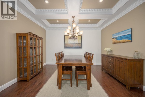Dining room with a wooden table and chairs, china cabinet, and sideboard. - 825 Robinson Street, Coquitlam