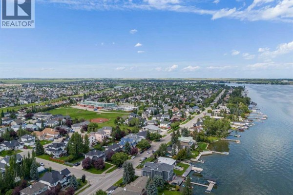 Aerial view of a suburban neighborhood with Chestermere Lake on the right side. - 828 West Chestermere, Chestermere