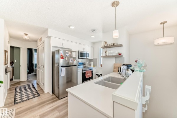 Entryway with a modern front door and staircase leading to upper levels. - #83 1203 163 St Sw, Edmonton