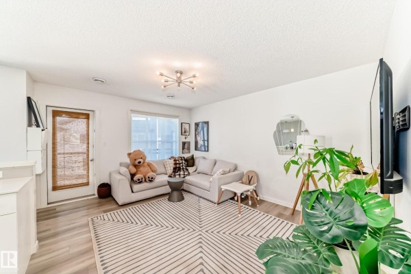 Kitchen area showcasing a sink, countertops, and open layout with natural light. - #83 1203 163 St Sw, Edmonton