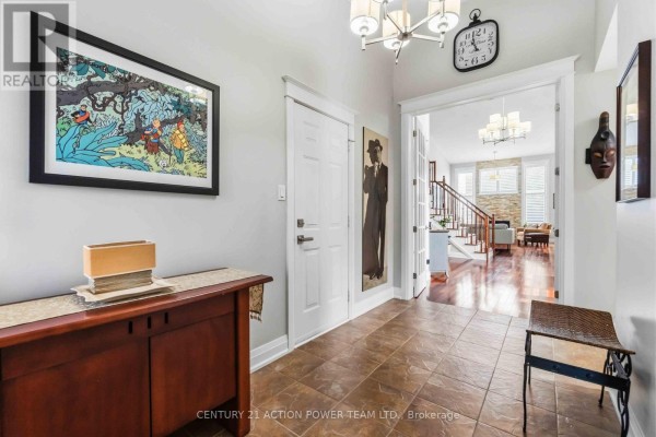 View from the entrance hall showing French doors opening to a living area with staircase. - 83 Blackshire Circle, Ottawa