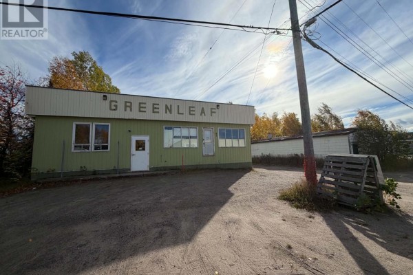 Front exterior of commercial building with "GREENLEAF" signage, green siding, and large windows. - 83 Hamiltion River Road, Happy Valley   Goose Bay