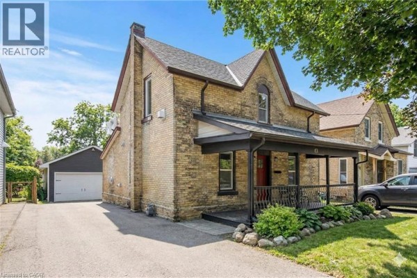 Front door with a glass inset and a digital lock, set in a light brick exterior. - 83 Oxford Street, Woodstock