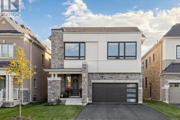 Front exterior of a contemporary two-story home with stone accents and a paved driveway. - 83 Vasey Road, Bradford West Gwillimbury