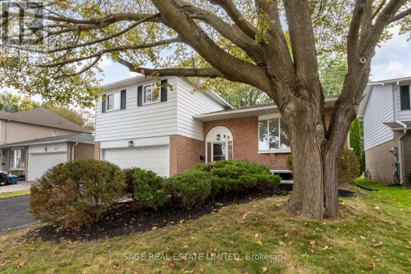 Side view of house exterior with mature tree and landscaping in front yard. - 83 Waverley Road, Clarington