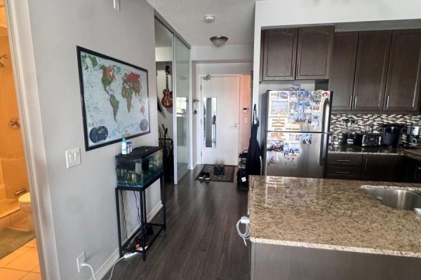Apartment interior showing a small entryway leading to a kitchen and bathroom. - 830 - 15 James Finlay Way, Toronto