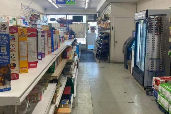 View of a convenience store interior showing cereal boxes, shelves, and a cooler. - 830 Wilson Avenue, Toronto