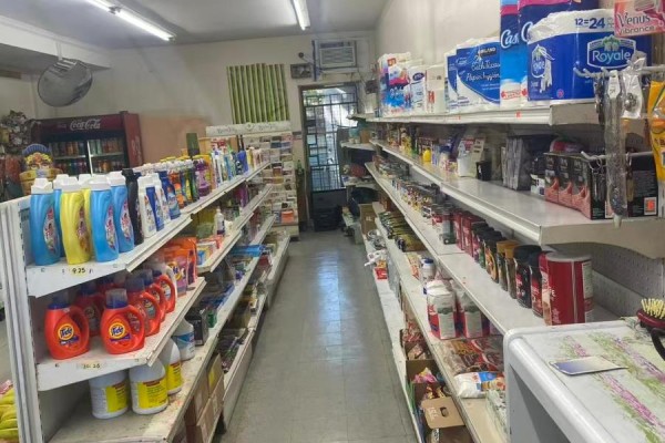 Aisles of cleaning supplies and other products on shelves inside a convenience store. - 830 Wilson Avenue, Toronto
