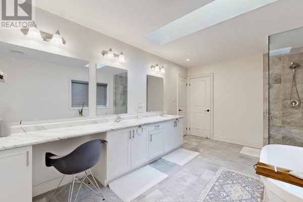 Bedroom with tufted headboard bed, dresser, and ensuite bathroom view - 833 Langford Boulevard Bradford West Gwillimbury