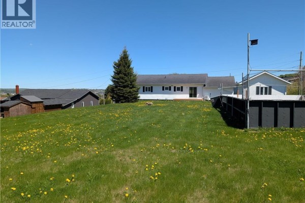 Aerial view of the property showing the main house, deck, and detached garage - 835 Walker Street, Grand Falls
