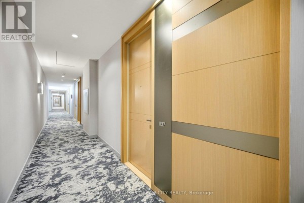 Main entrance featuring glass doors, planters, and stone pathway - 837 - 39 Queens Quay E, Toronto
