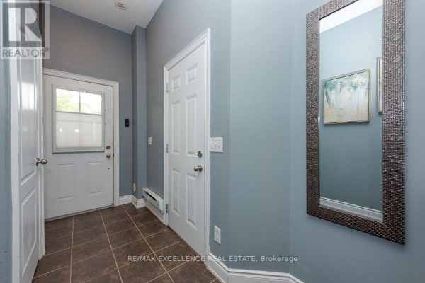 Interior entryway with blue walls, tiled floor, and white doors. - 84 - 110 Cedar Lake Crescent, Brampton