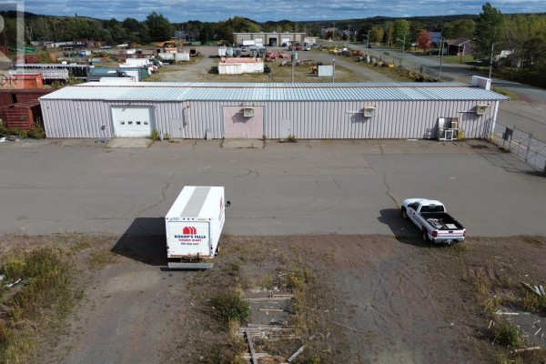 Rear view of building with loading dock and construction materials - 84-90 Main Street, Bishop S Falls