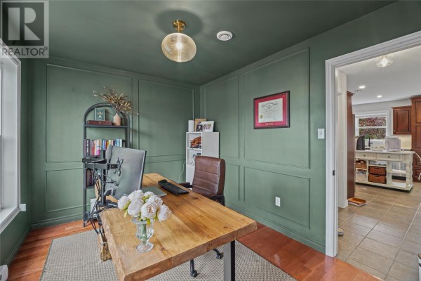 Home office with dark green walls, wood desk, leather chair, and bookshelves. - 84 Gil Eannes Drive, St  John S