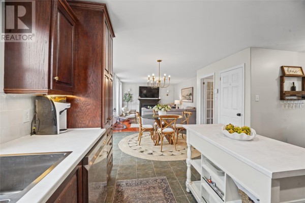 View from kitchen into dining area with chandelier and living room beyond. - 84 Gil Eannes Drive, St  John S