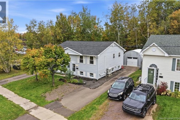 Aerial view of the house showing the exterior, driveway, and garage. - 84 Glencoe Drive, Moncton